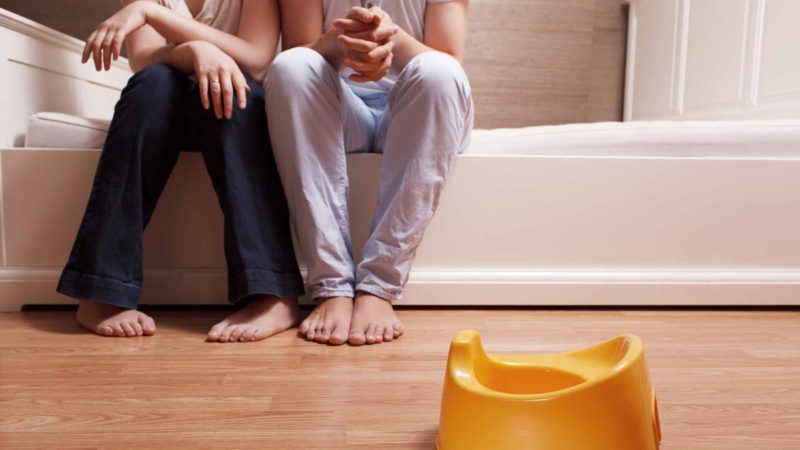 Parents Sitting Bed Potty Training